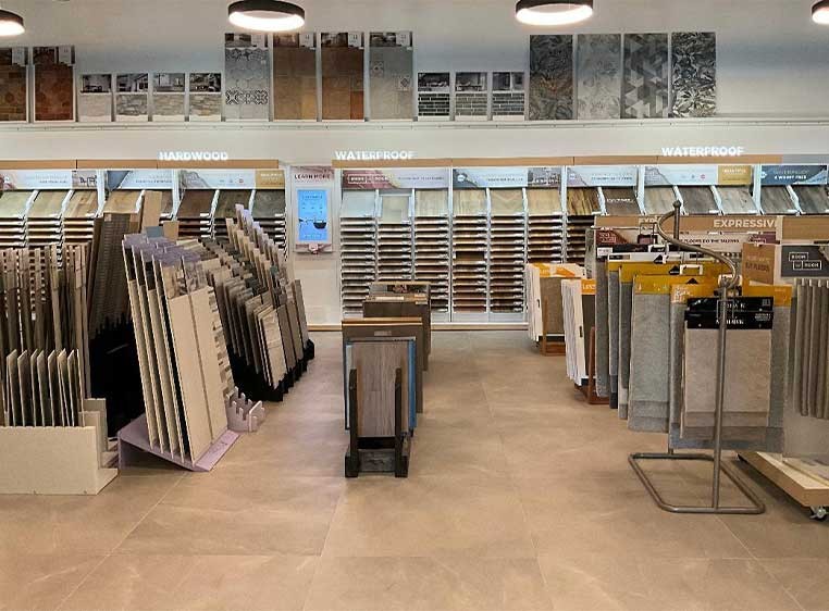 Store interior showcasing several different types of window coverings, fabrics, and flooring